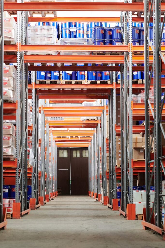 Wide angle view of a warehouse with stocked shelves and boxes.